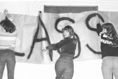 1980 Yearbook pg043 3 females hanging banner